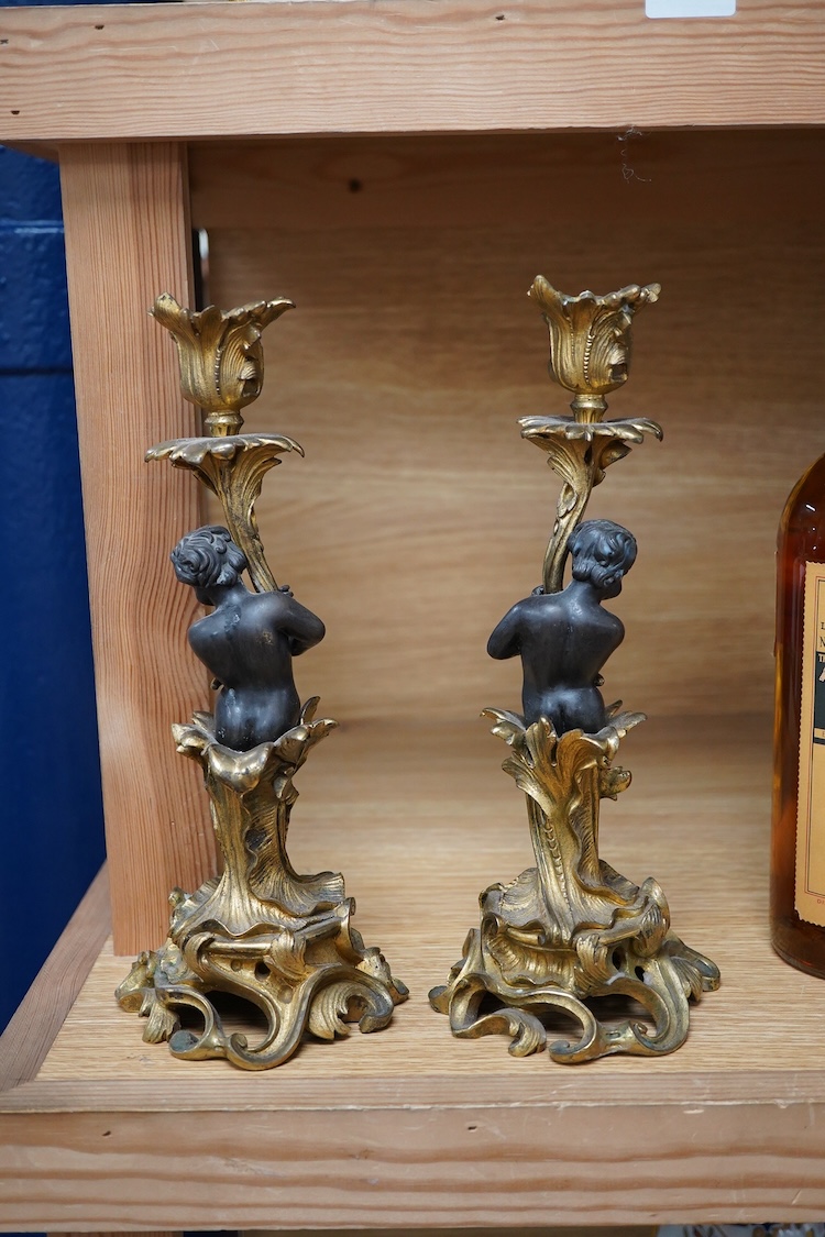 A pair of decorative French ormolu figural candlesticks, 25.5cm high